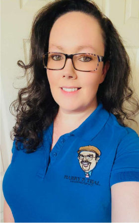 A woman is smiling in front of a cartoon of a man in a suit and tie.