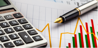 Calculator and pen on a graph paper with financial charts, suggesting business and analysis.
