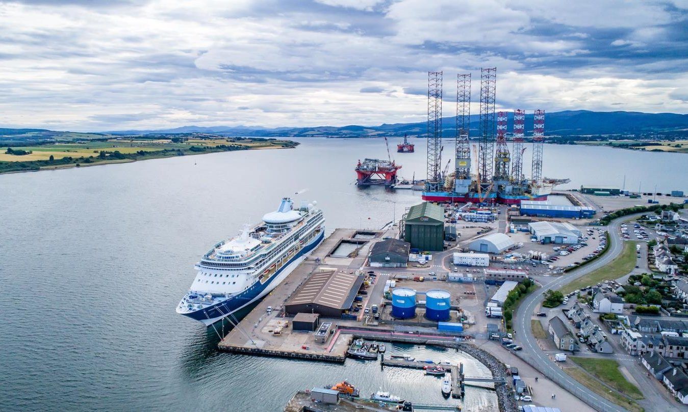 An aerial view of a cruise ship docked in a harbor.