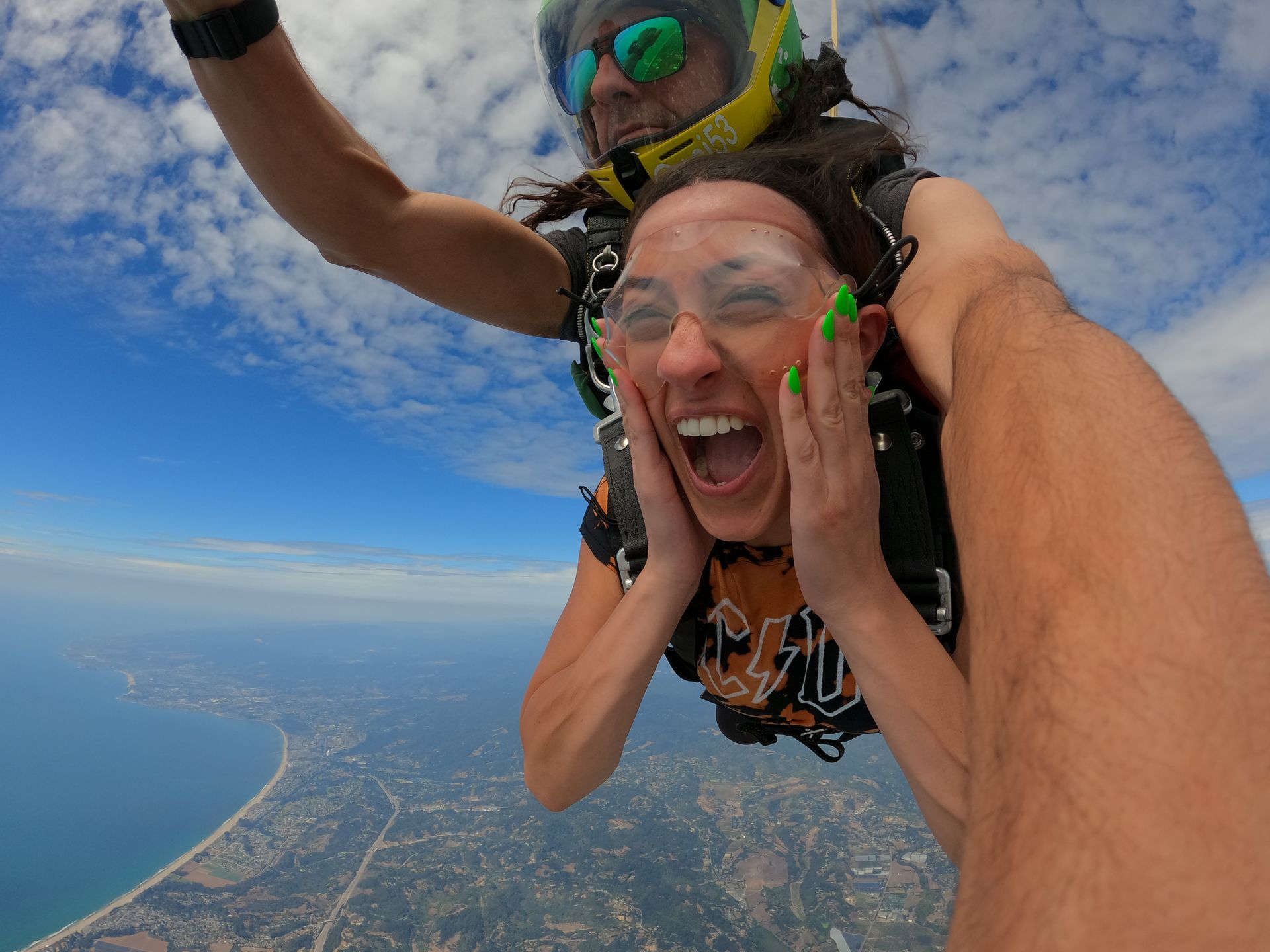 Woman makes OMG facial expression during tandem skydive. 