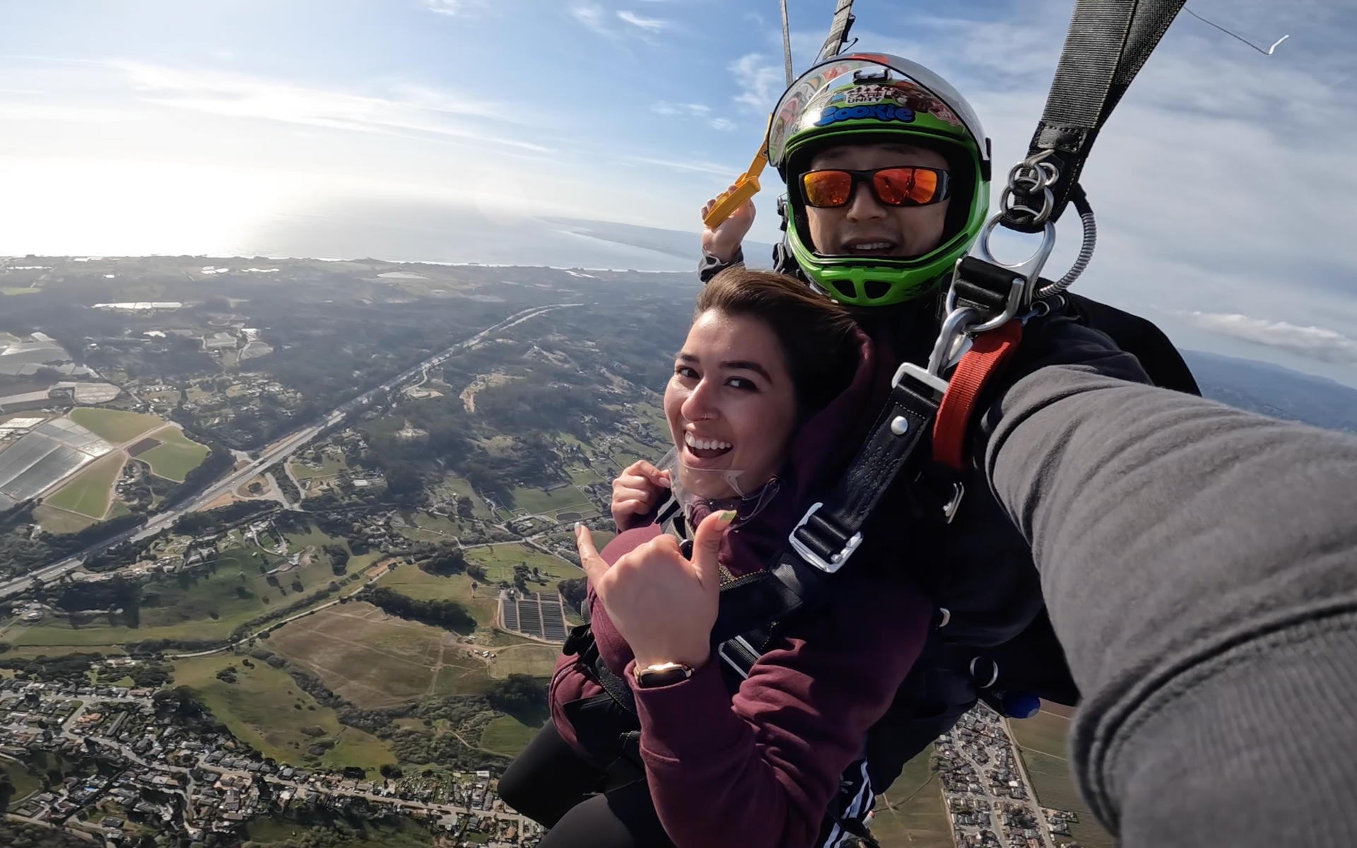 Skydive Santa Cruz tandem pair flying through the air on a parachute.