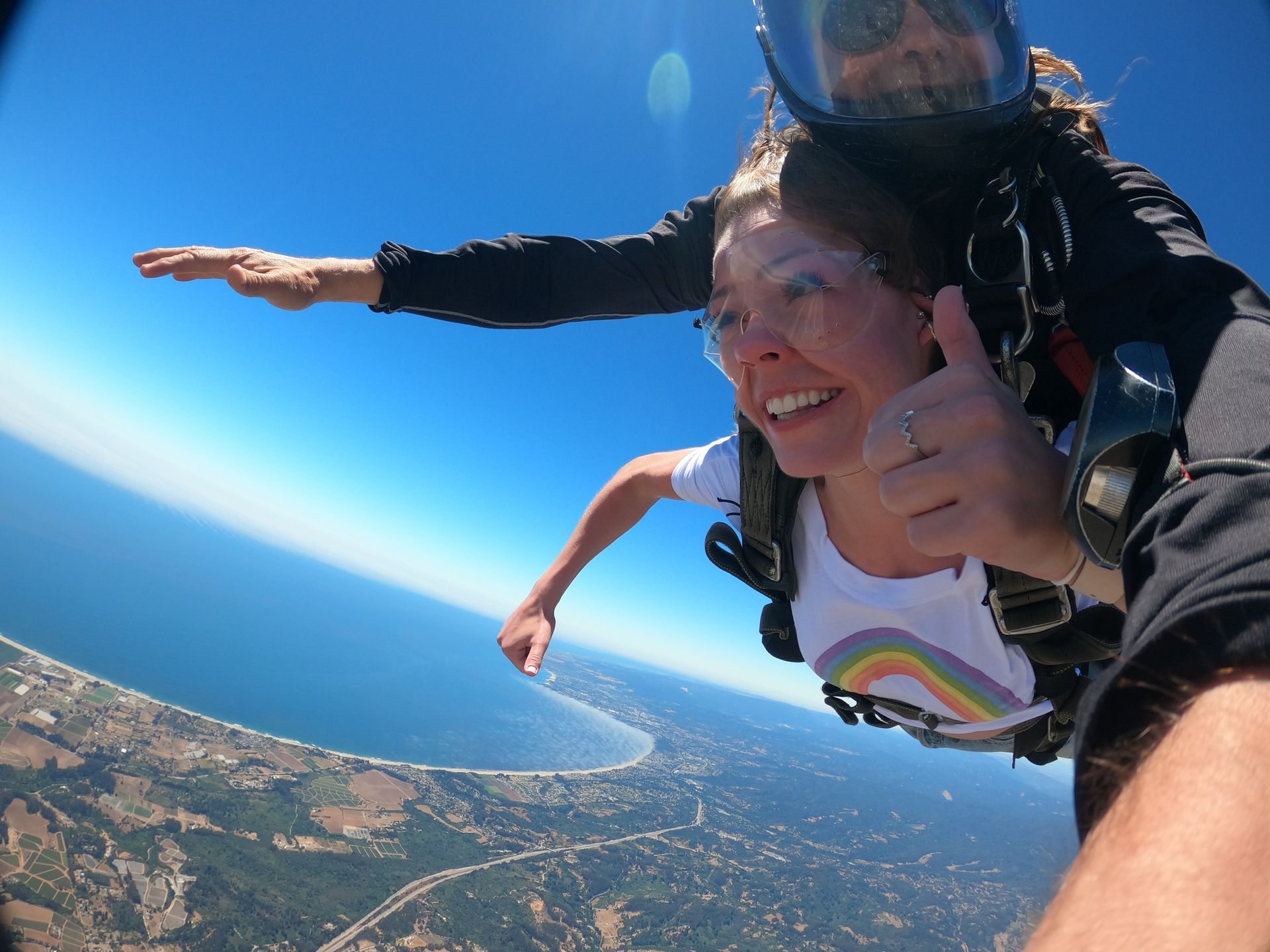 Skydive student gives a thumbs up during tandem skydive at Skydive Santa Cruz.