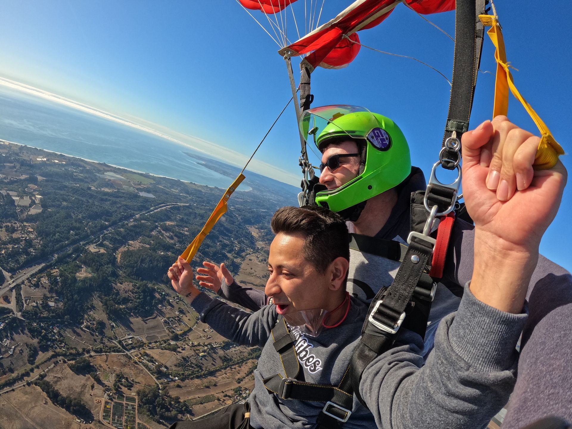 Tandem student flies parachute during descent over Skydive Santa Cruz. 