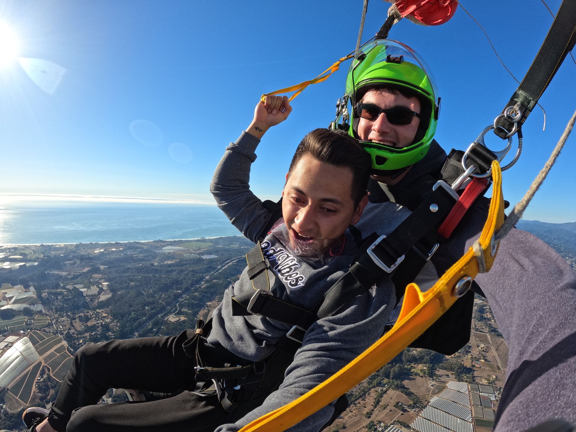 Tandem skydive student makes a turn during parachute by pulling down toggles near Skydive Santa Cruz. 