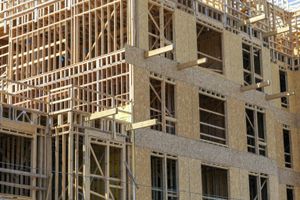 A large building is being built with a lot of wooden beams.