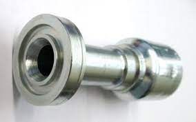 A close up of a metal object with a hole in it on a white surface.