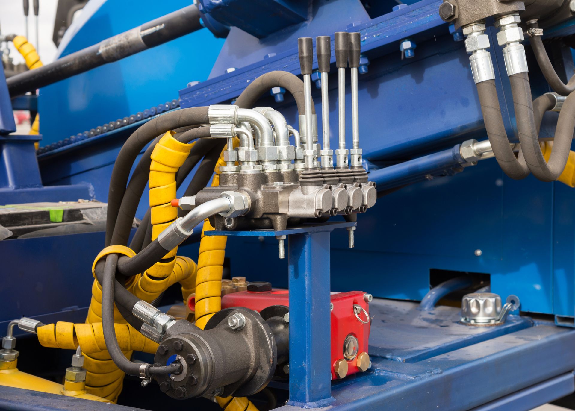 A close up of hydraulic hoses on a machine.