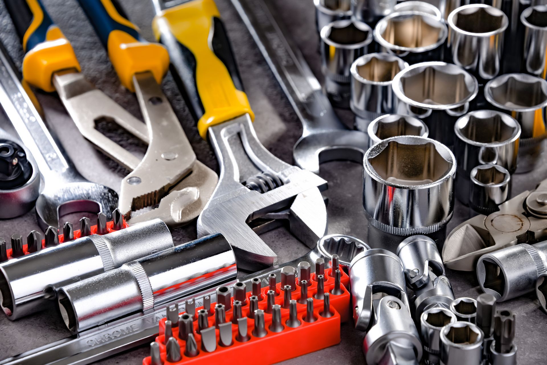 A bunch of tools are sitting on top of each other on a table.