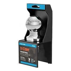 A stainless steel trailer hitch ball in a box.