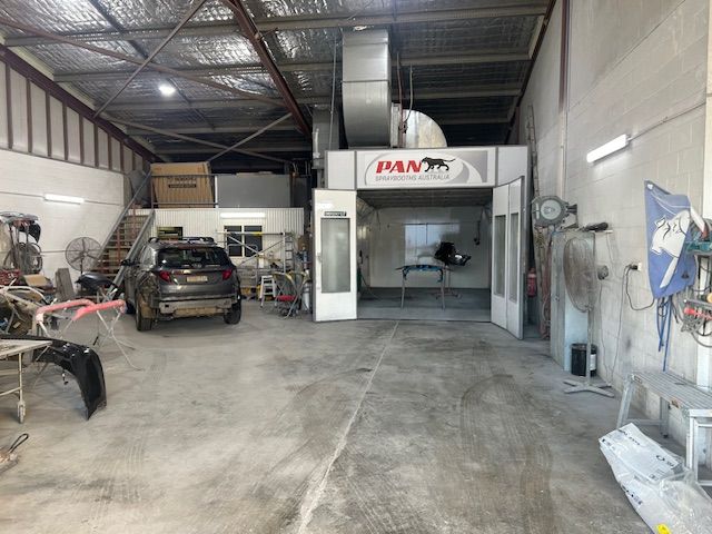 Interior of a Car Repair Shop With a Paint Booth — T & C Smash Repairs In Coffs Harbour, NSW