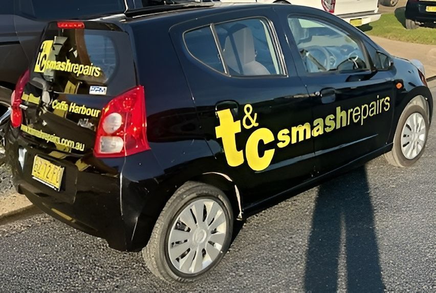 Black Car With a Business Signage — T & C Smash Repairs In Coffs Harbour, NSW