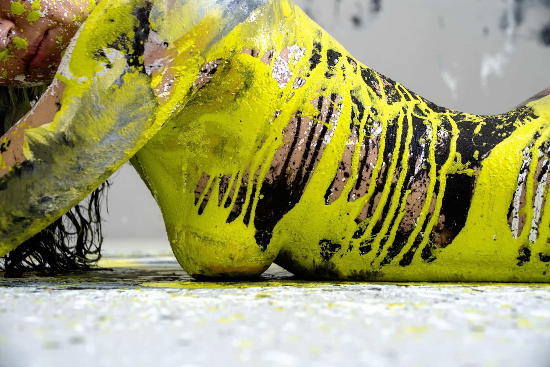 Close-up of a female model covered in bright yellow and black body paint during a stag party body painting session