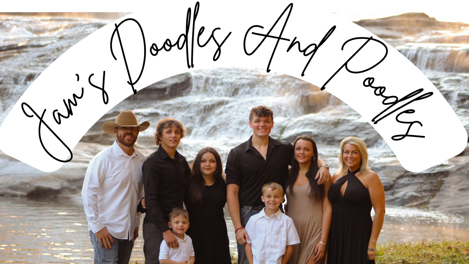 Family portrait in front of a waterfall, with 
