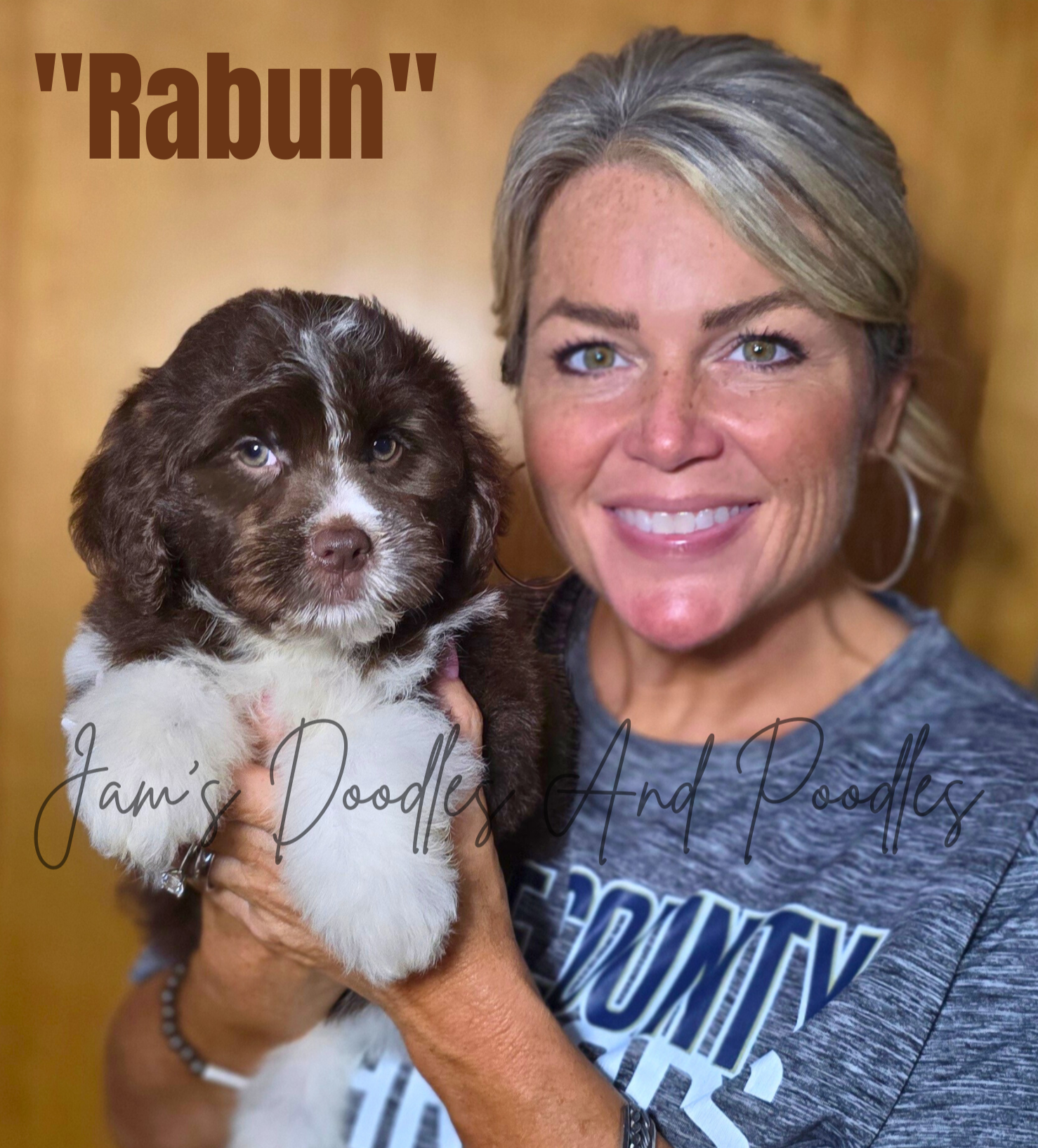 Woman holding a brown and white puppy named 