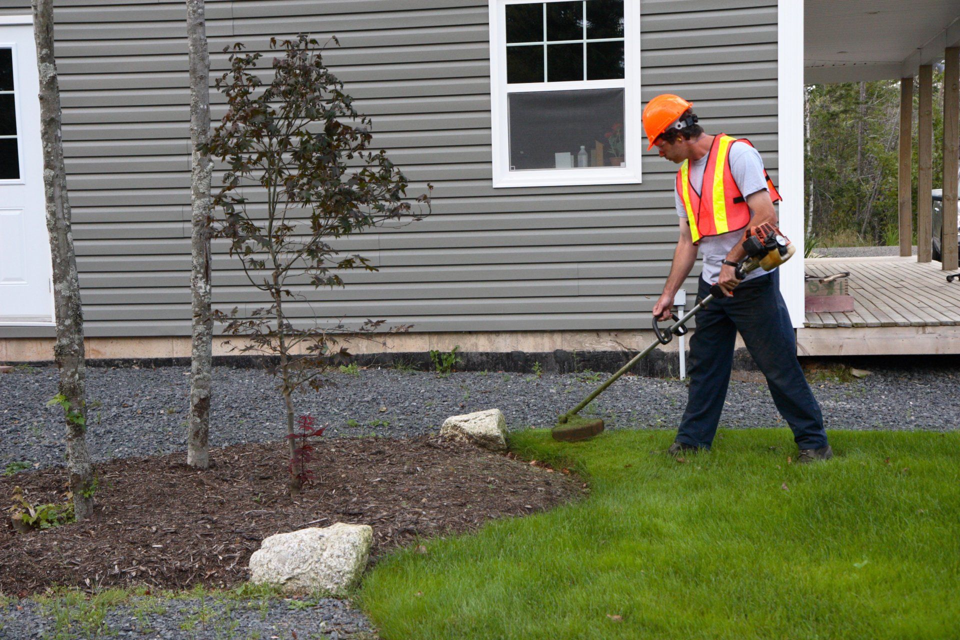 Man Trims Grass - Canton, OH - Warstler Bros Landscaping