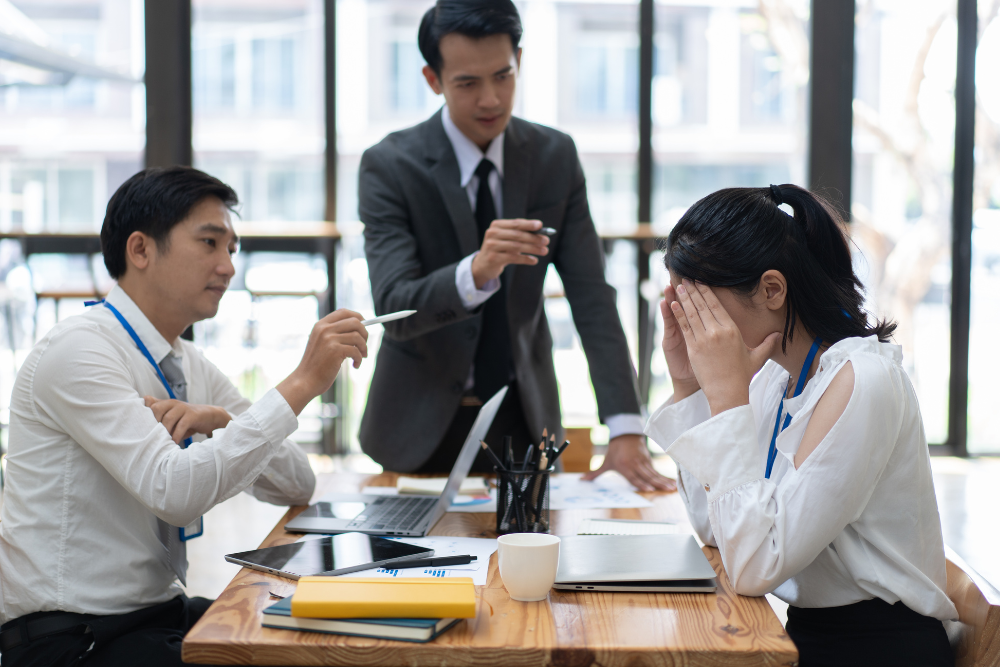 A group of business people are sitting at a table having a meeting.