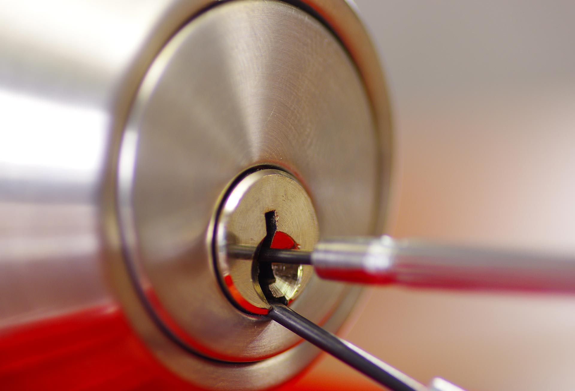 Close-up of locksmith tools working inside a commercial door lock cylinder. Close-up of locksmith tools working inside a commercial door lock cylinder.