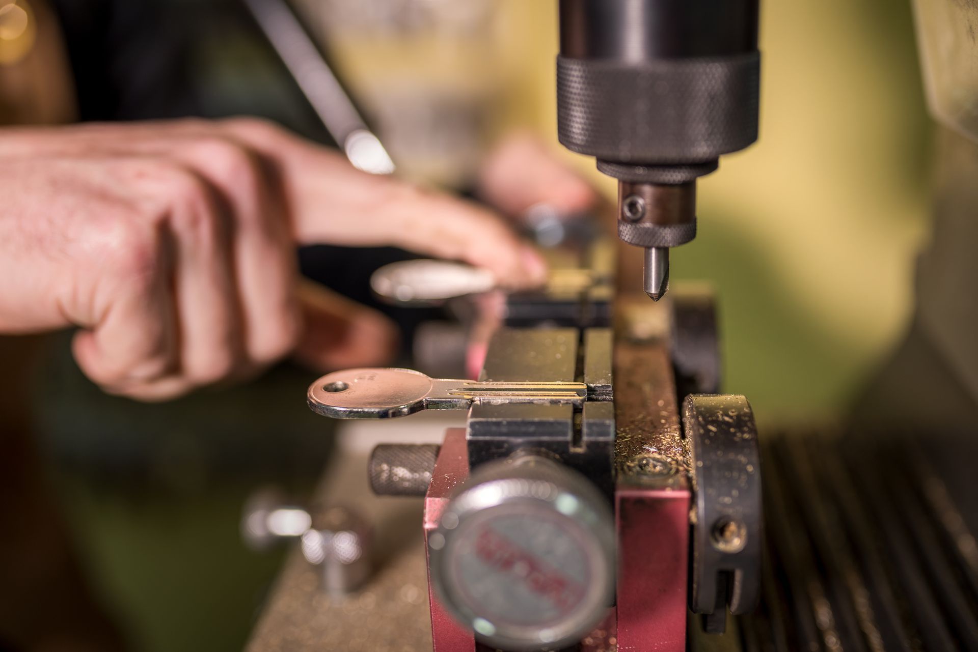 Key duplication process, specialized machine copying metal key with professional precision — Hampton, VA — Shorty Wallin Lock & Security