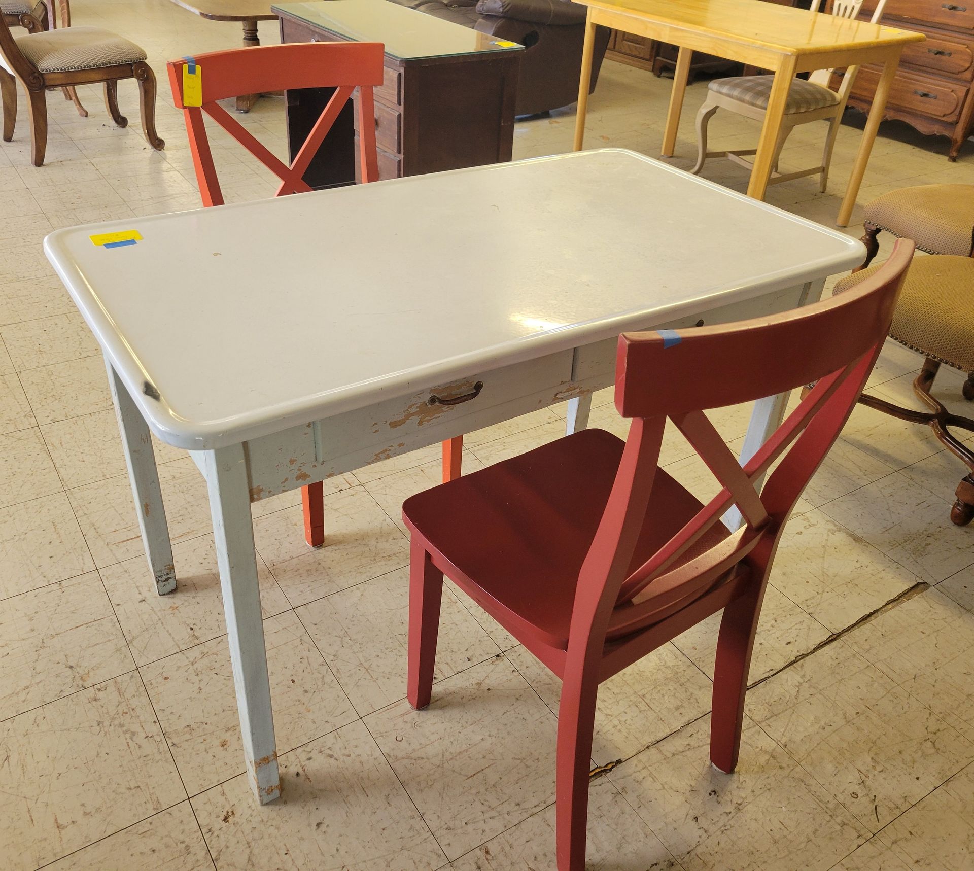 A white table with a red chair in front of it - Mountain Home, AR - Chuck's Outlet & Moving Inc