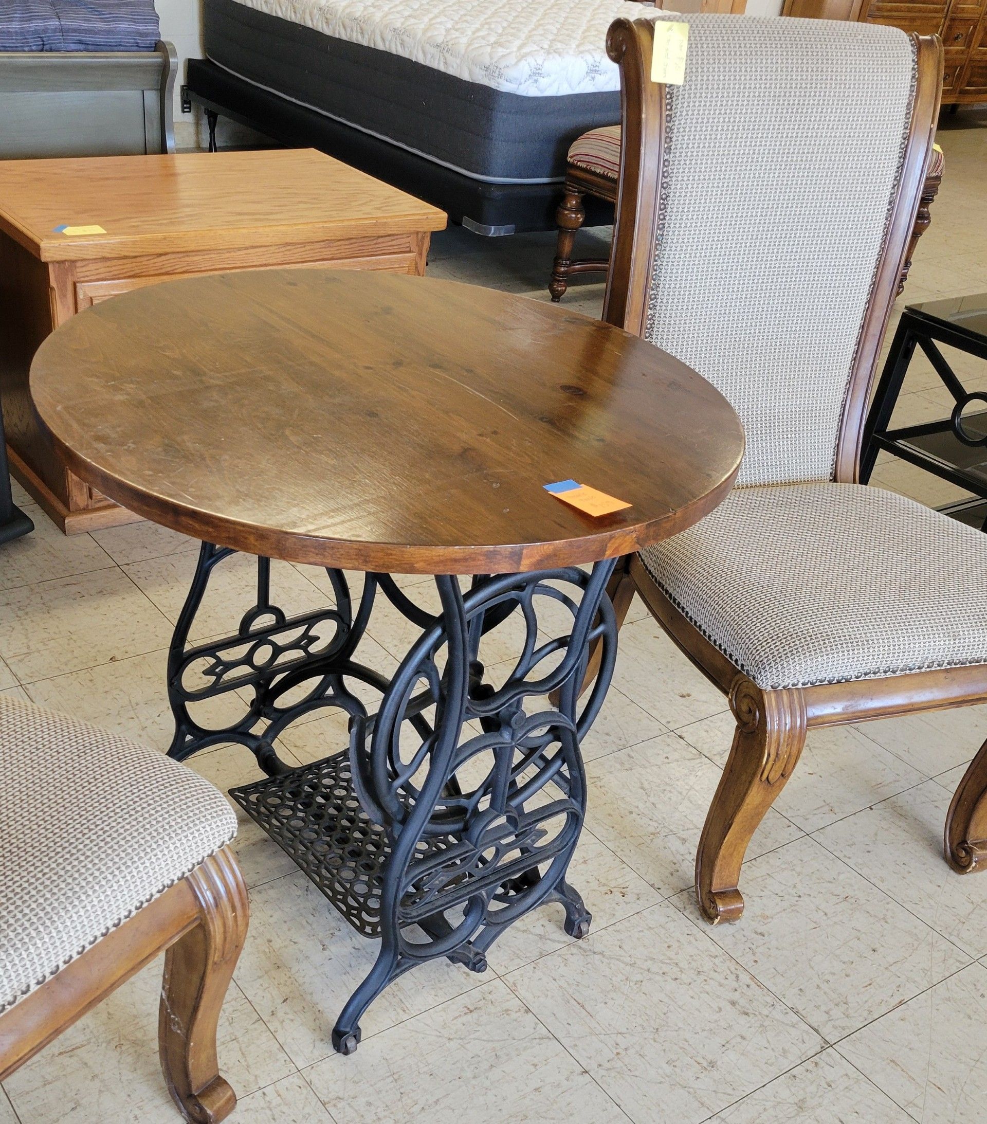 Two upholstered armchairs with floral pattern, brown wood frames.