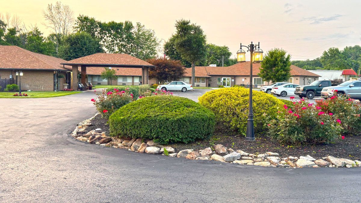 A parking lot with cars parked in front of a building.