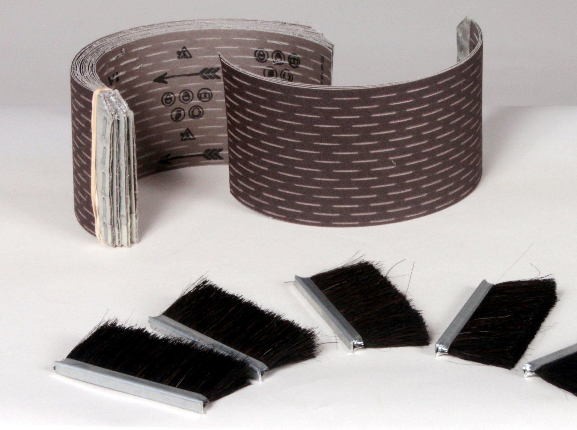 Sand-Rite flap sander replacement brushes and slash paper abrasive loading.
