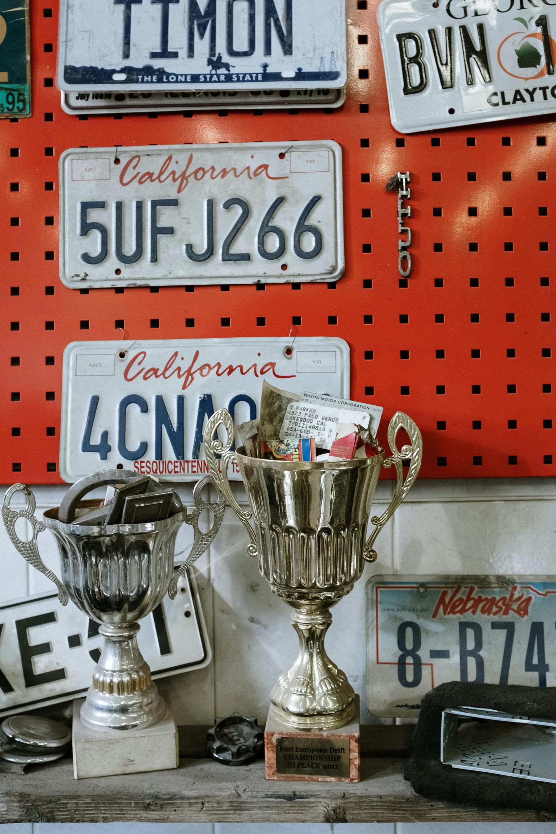 A display of trophies and california license plates including 5uf j266