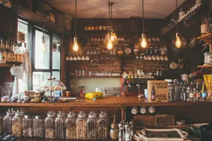 A restaurant with a lot of jars and bottles on the counter.