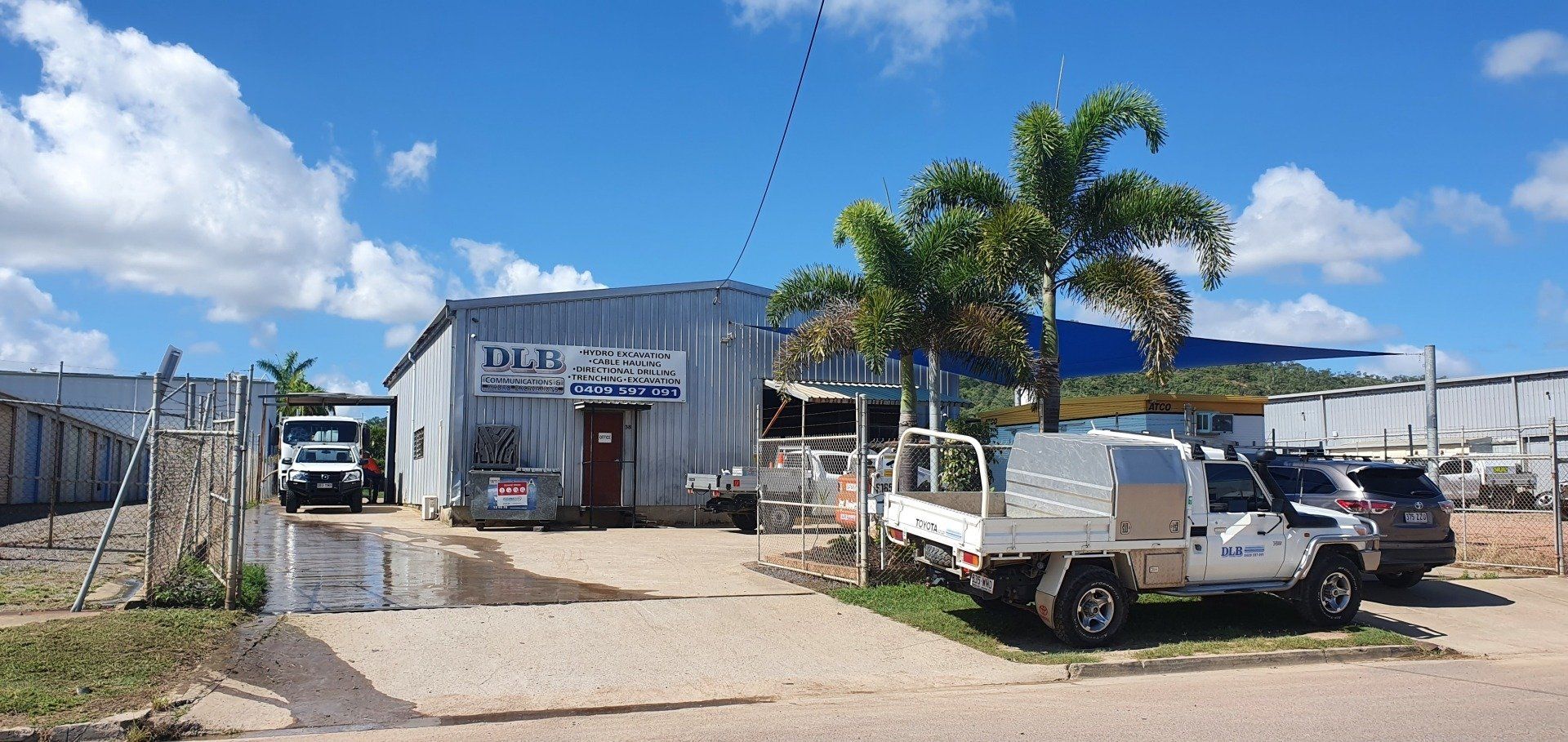 A Worker On A Ladder — Providing Communications and Hydro Excavation Services in Townsville, QLD