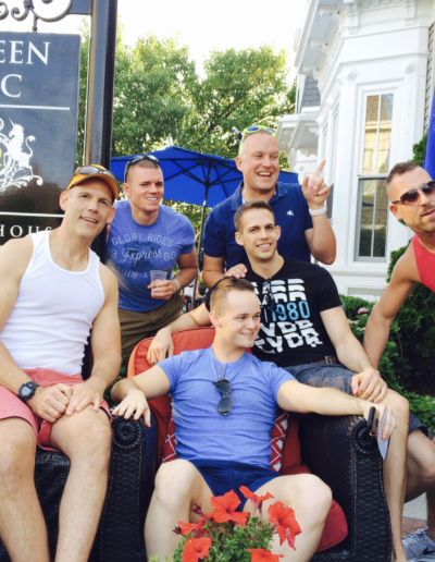 A group of men are posing for a picture in front of a sign that says een c