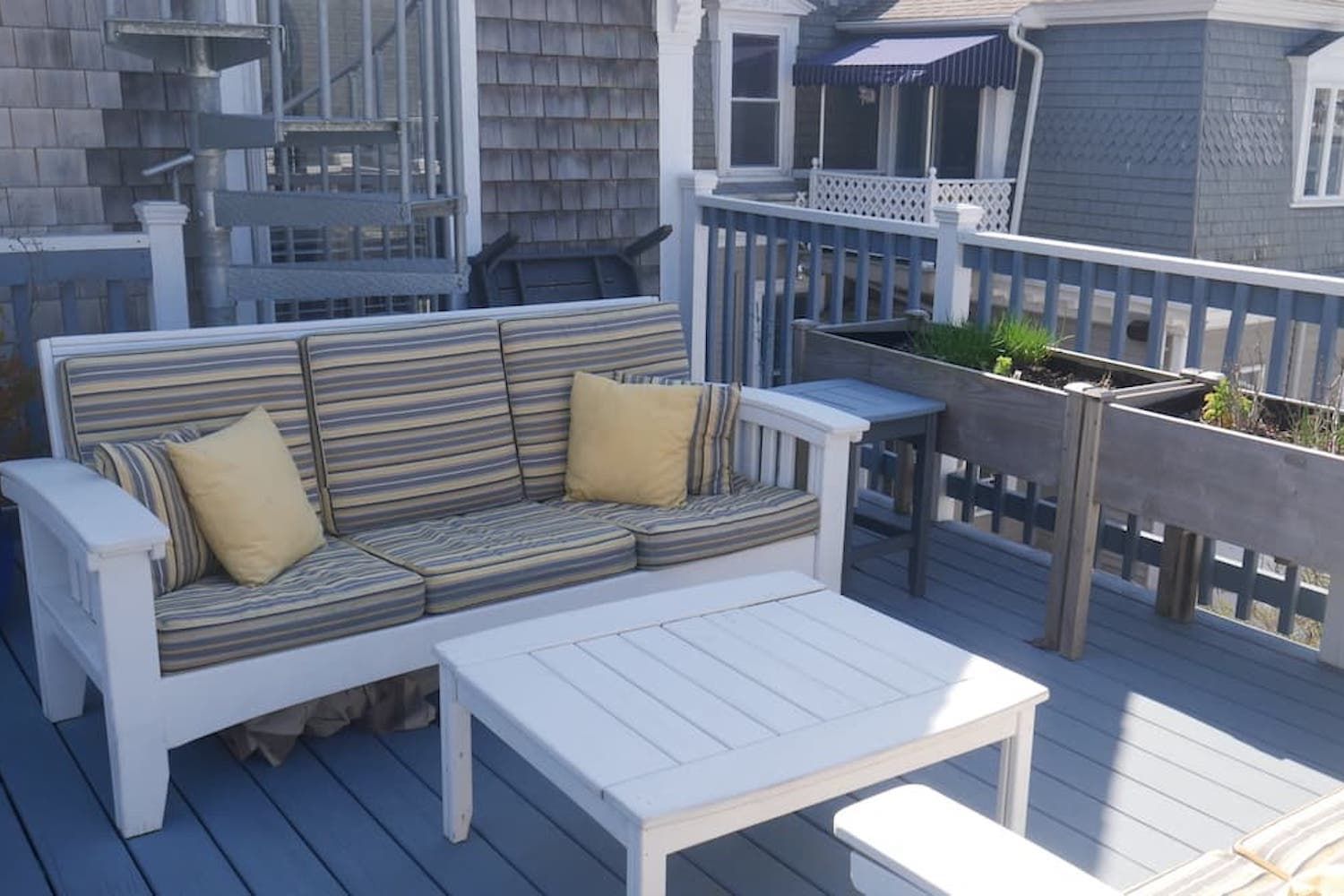 A deck with a couch and a table on it