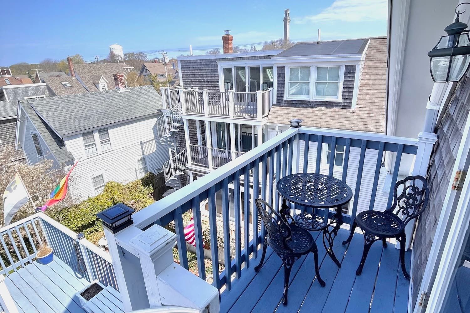 There is a balcony with a table and chairs on it.