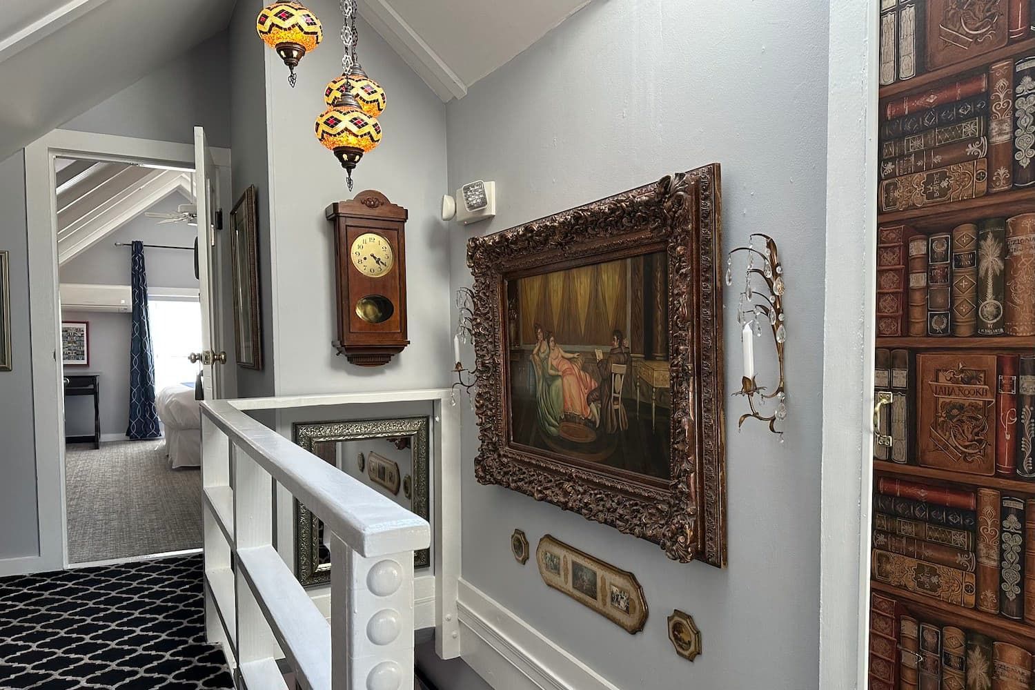 A hallway with a clock and a picture on the wall