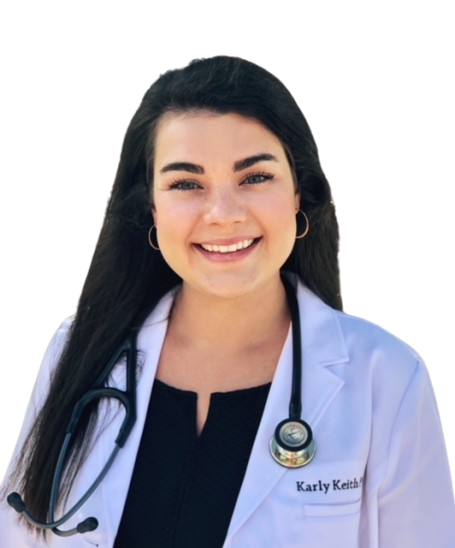 A person wearing a white lab coat over an orange dress, smiling and gesturing with thumbs held up.