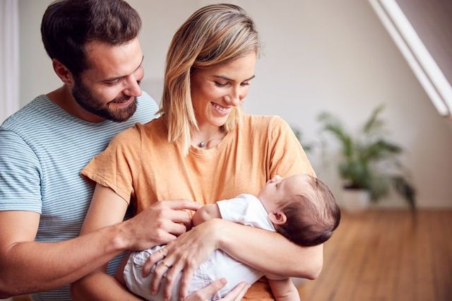 Modern parents using technology and apps to track baby's development and care