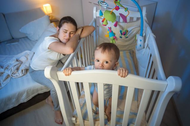 Baby sleeping in store corner of crib