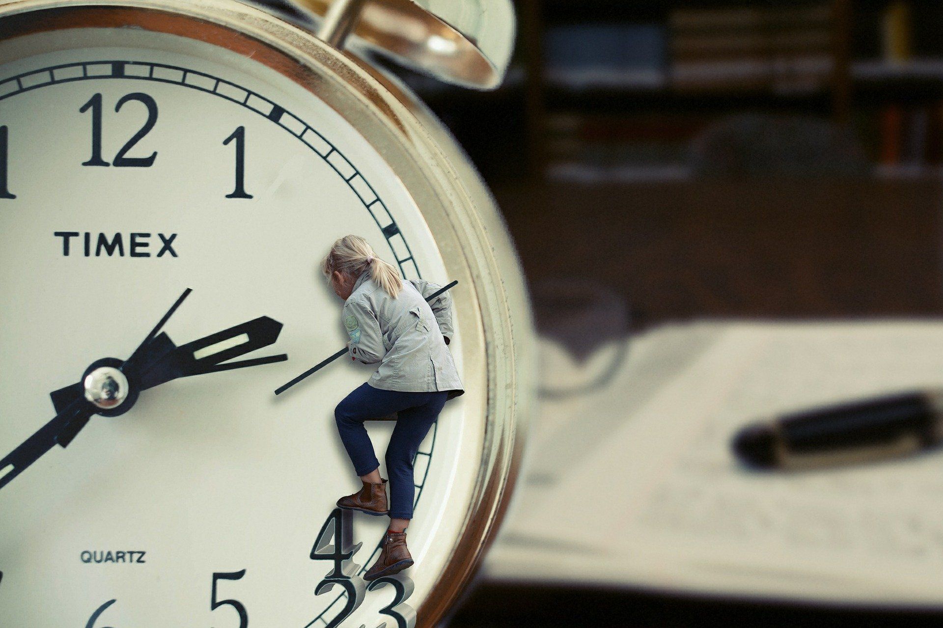 Young girl climbing on a clock