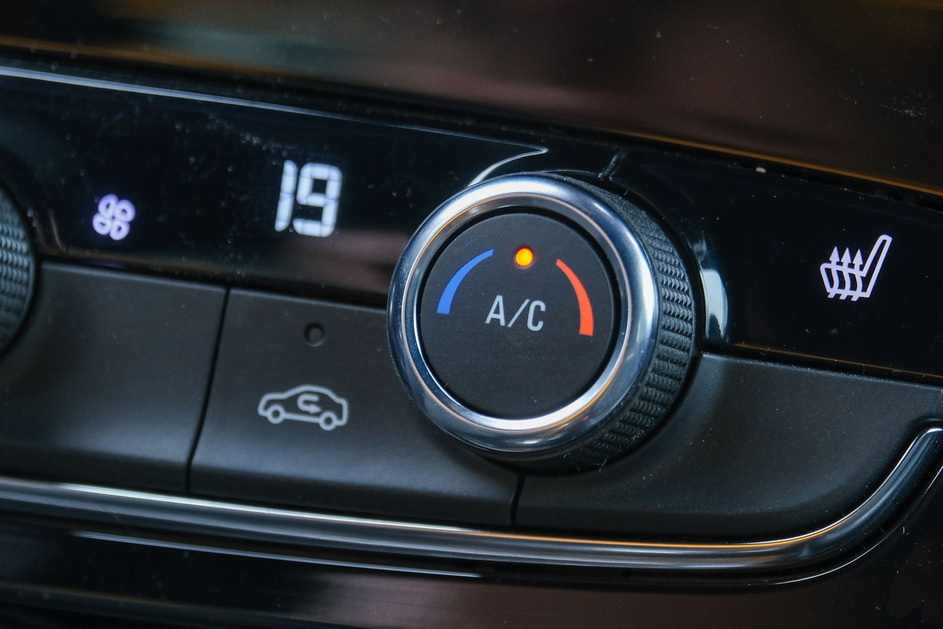 A close up of a car 's a / c control.