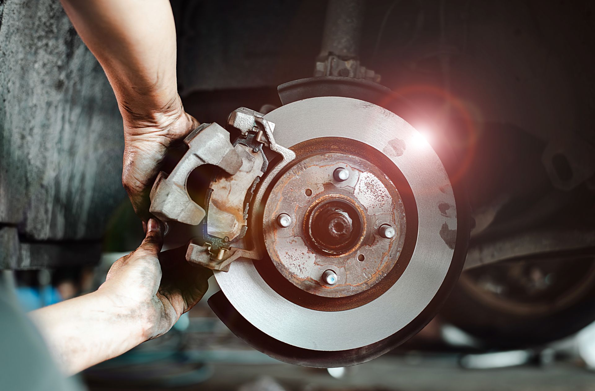 A person is fixing a brake disc on a car.