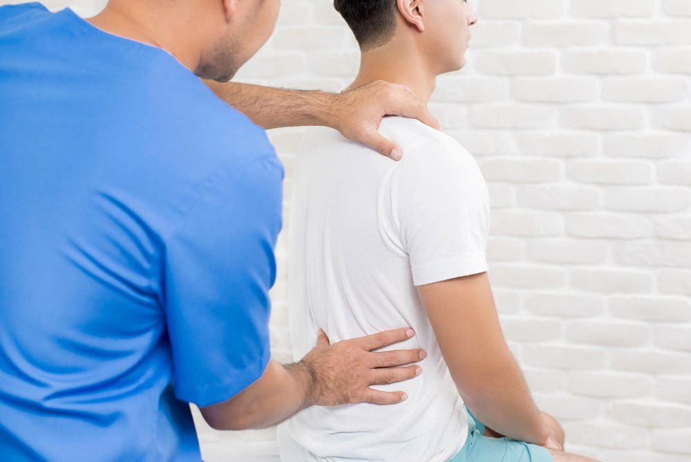 Man Having Chiropractic Back Adjustment — Zanesville, OH — Zanesville Medical Center