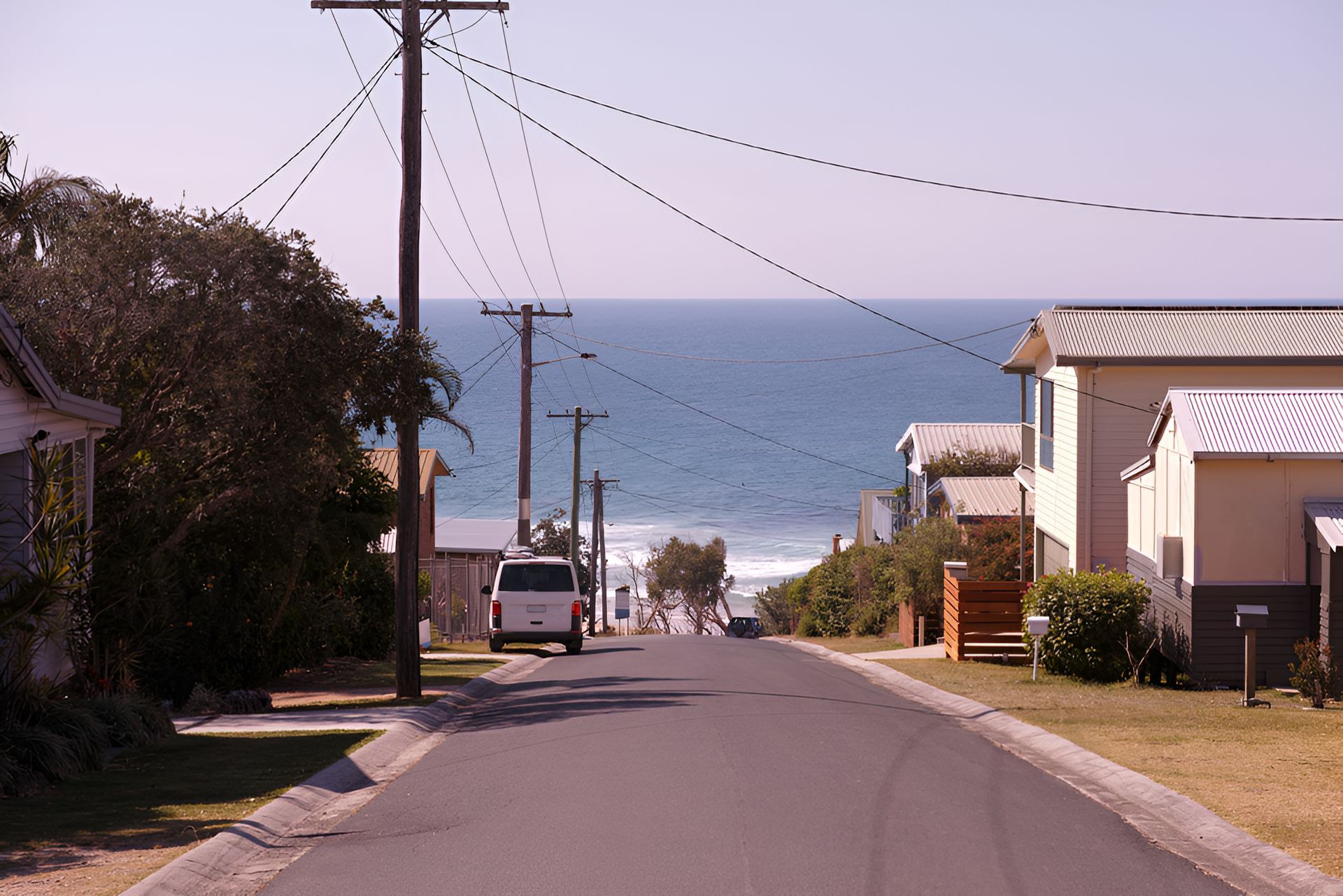 Street leading to the ocean; houses line the sides — Stuart Pearce Electrical In Coffs Harbour, NSW