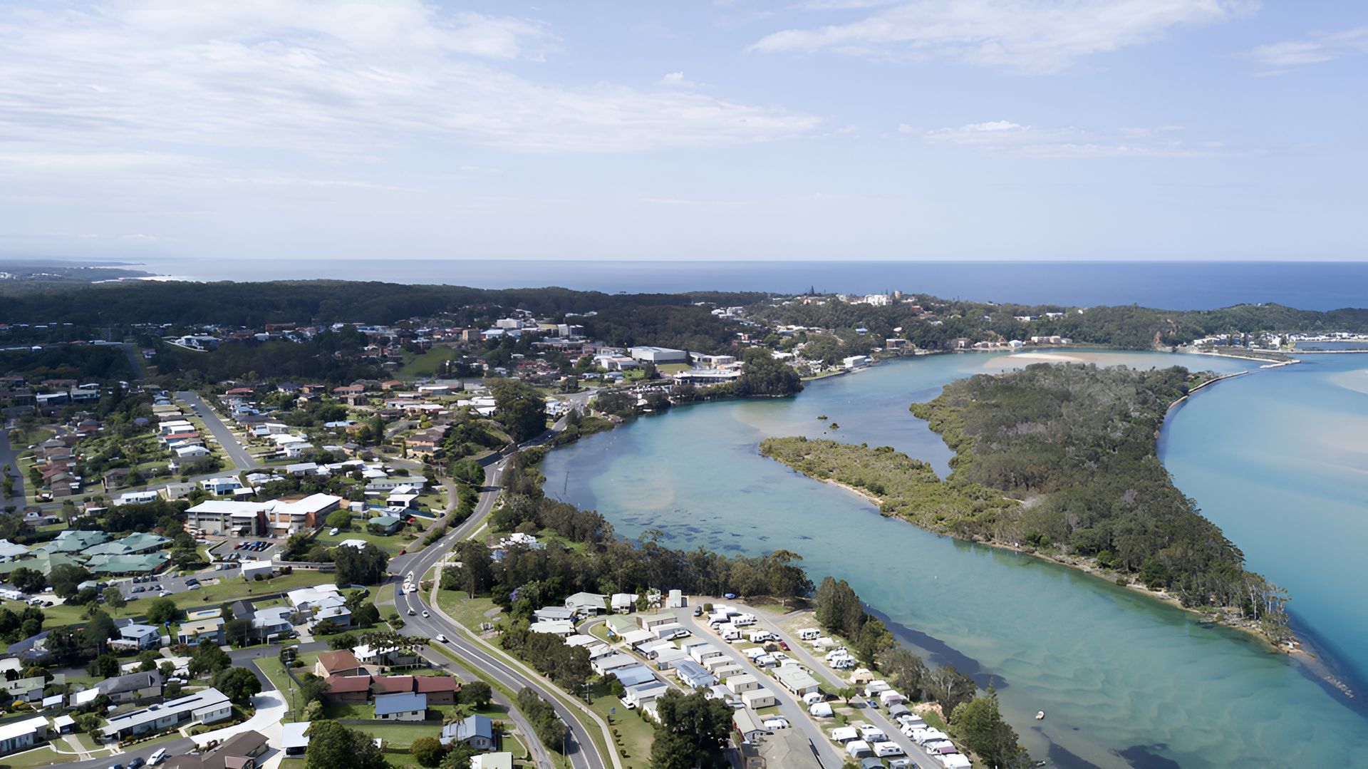 Aerial view of a coastal town, river, and ocean under a blue sky — Stuart Pearce Electrical In Coffs Harbour, NSW