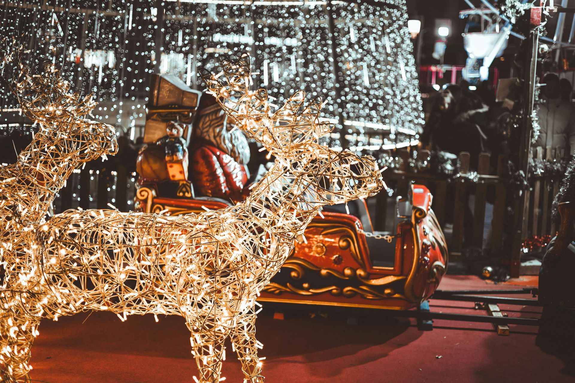 A two-story brick house with a shingled roof, surrounded by a manicured lawn and trees under a clear blue sky.