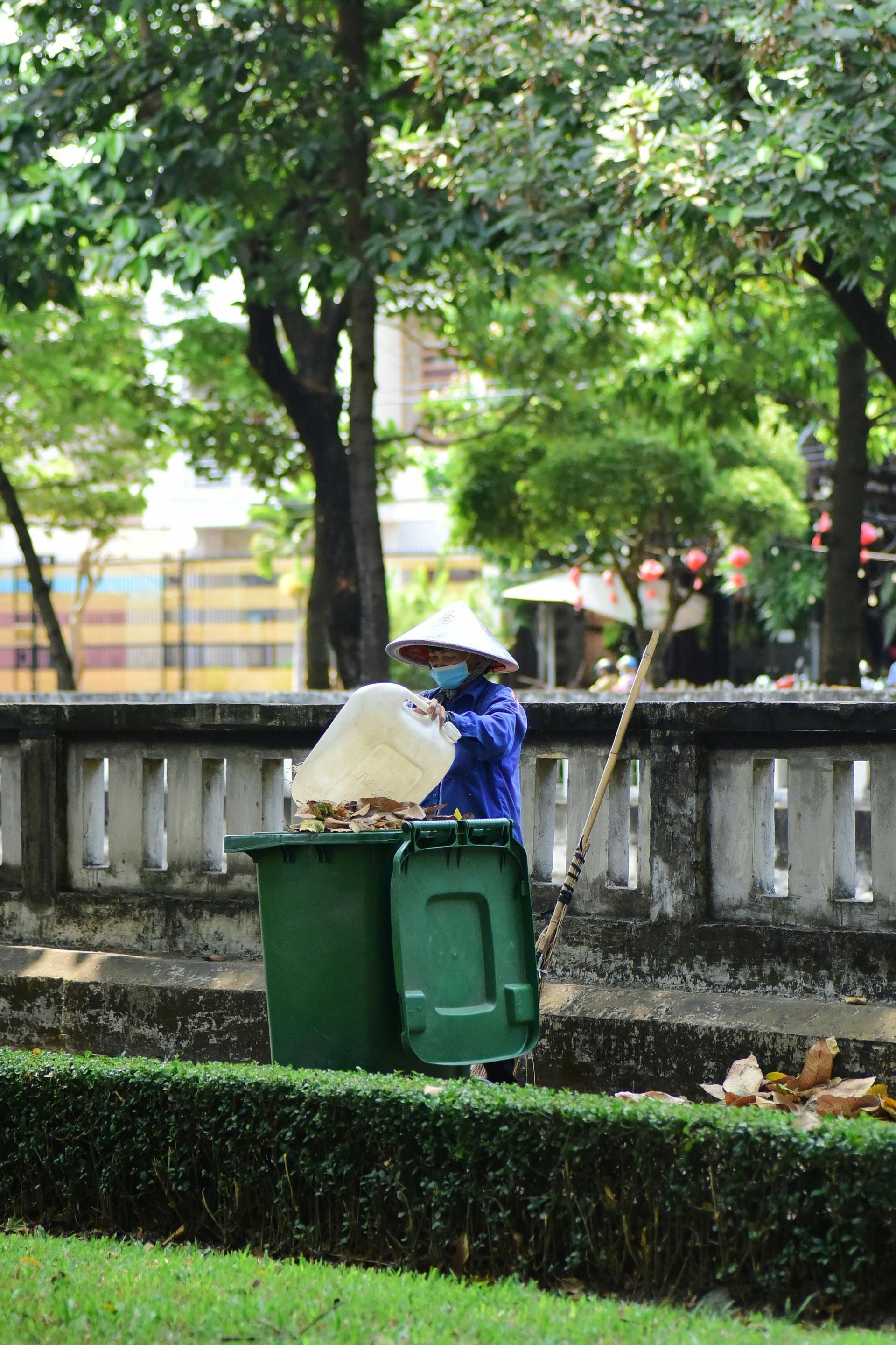 Front yard flower bed with pink azaleas beside a house and driveway