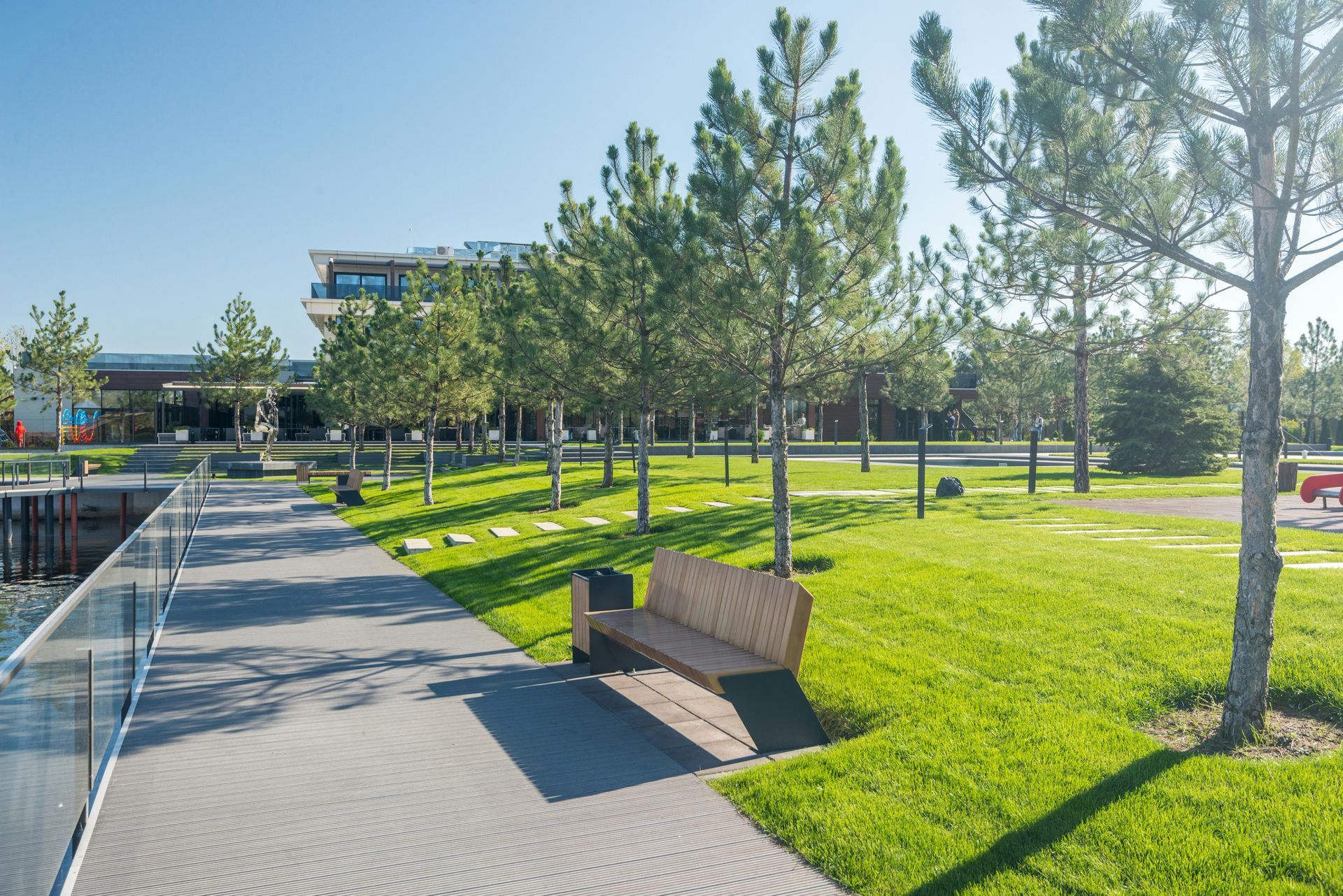 Front yard flower bed with pink azaleas beside a house and driveway