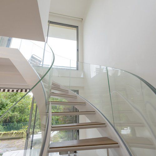 Atrium white interior with glass spiral staircase