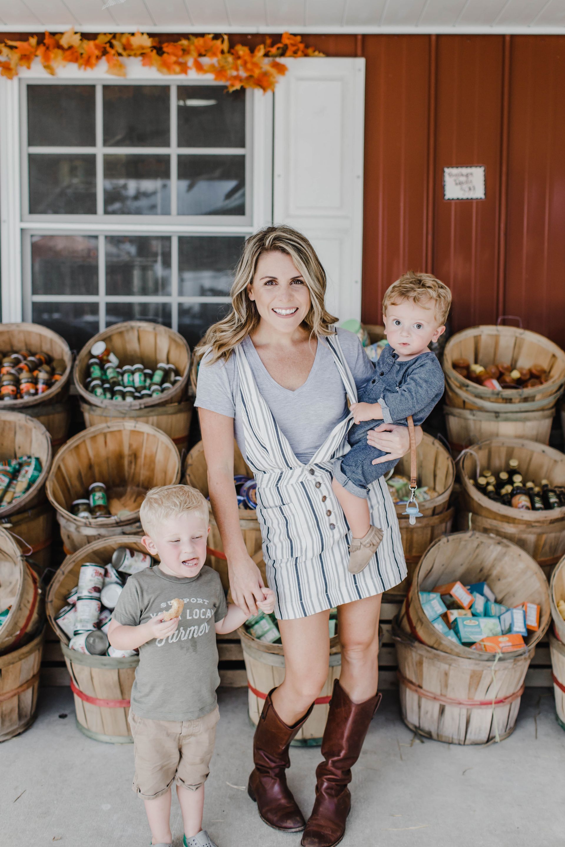 family picture of two boys and mom at farmer market