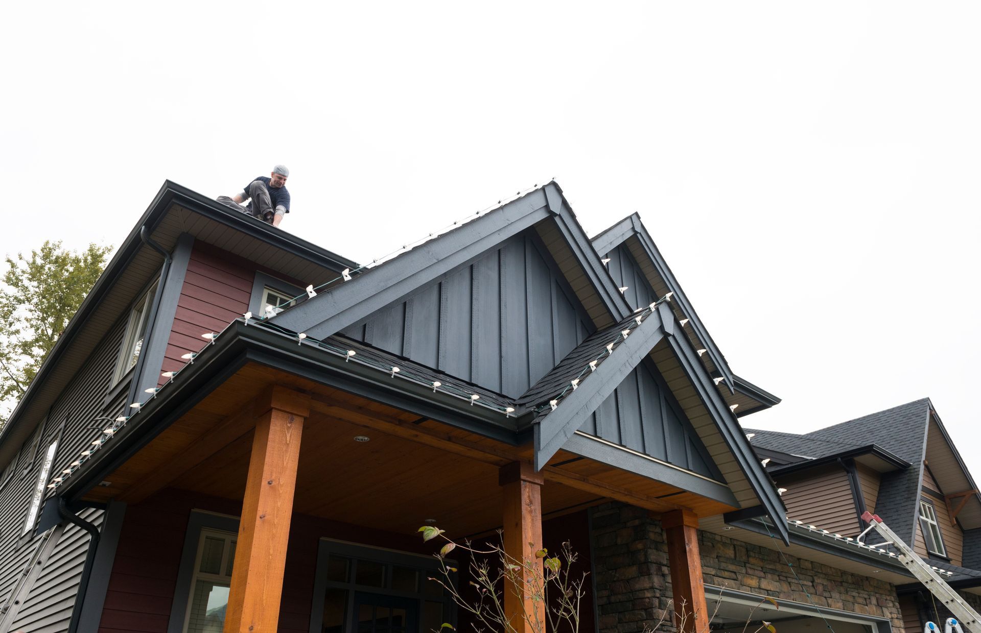 man on roof installing lights