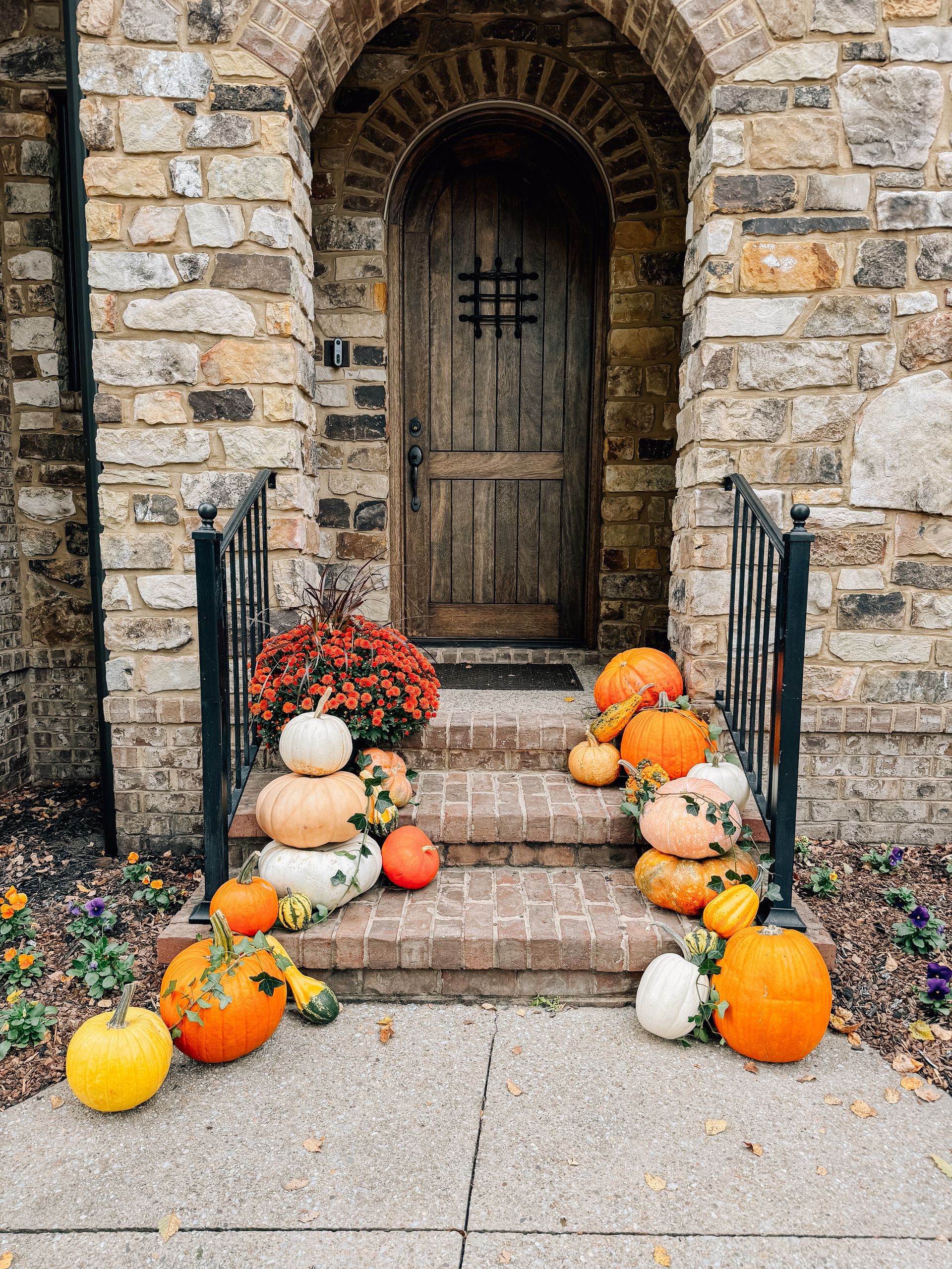 house with cascading pumpkins down the stairs