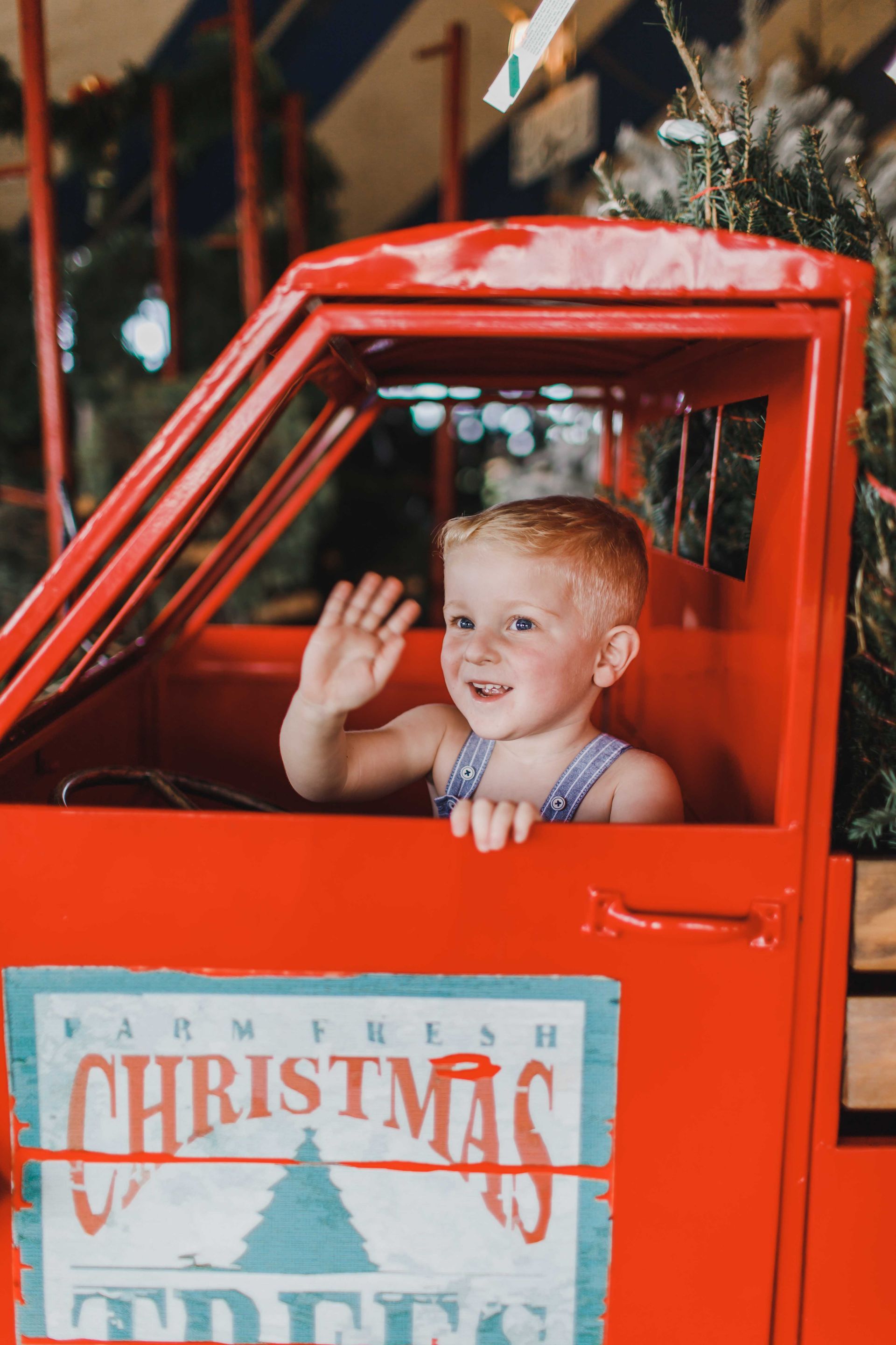 little boy in red pickup truck